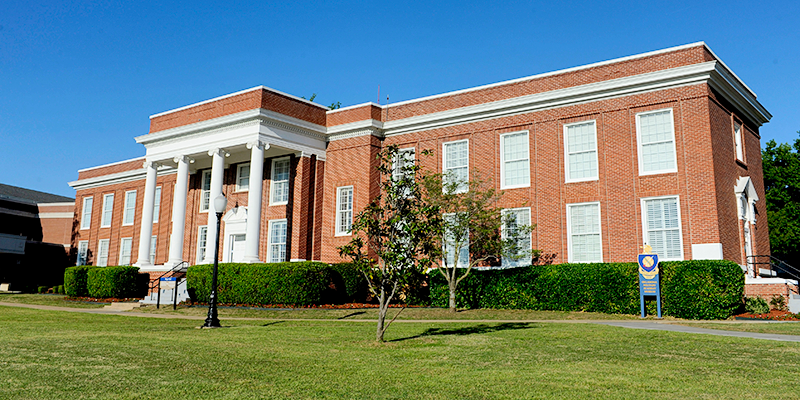 brick building with white columns