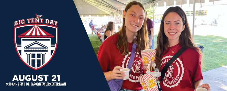 Two girls holding popcorn under big tent 