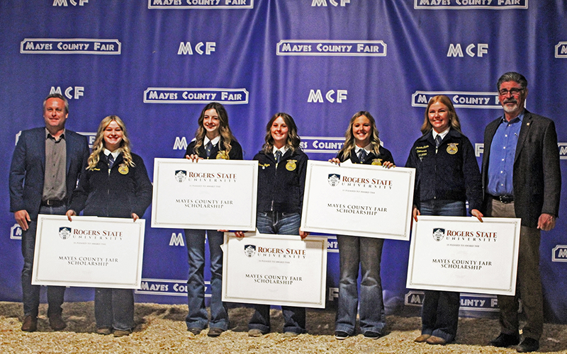 RSU Pryor Campus Director Brett Rowh (left) and RSU Interim President Dr. Mark Rasor (right) congratulate Rogers State University Mayes County Fair Scholarship recipients Emily Cowan, Emily Bond, Alissa Hagar, Courtney Holcroft and Christa Canida.