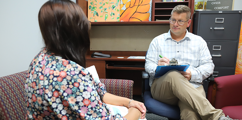 Man in counseling session with a woman.