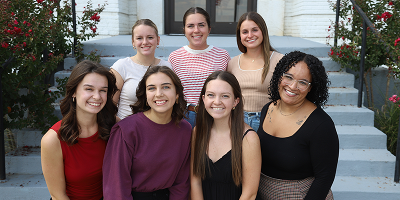 Girls standing on steps of building for photo