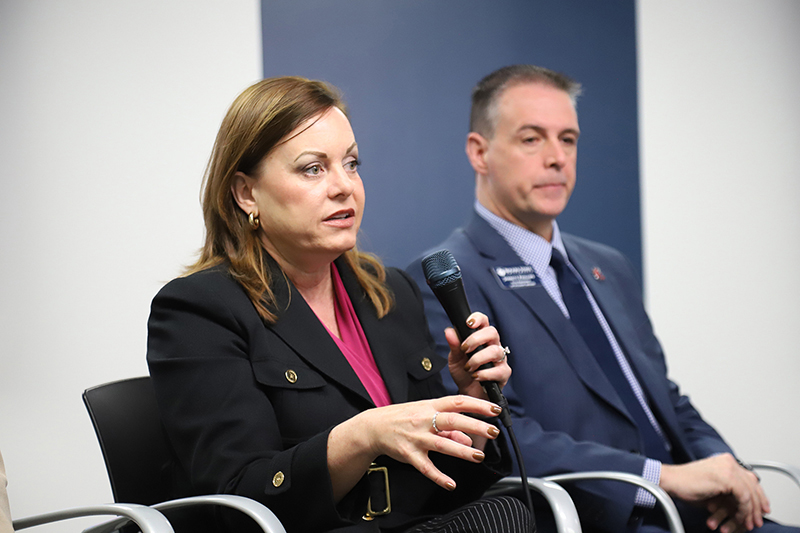 Woman panelist speaking into microphone