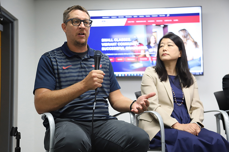 Man panelist speaking into microphone