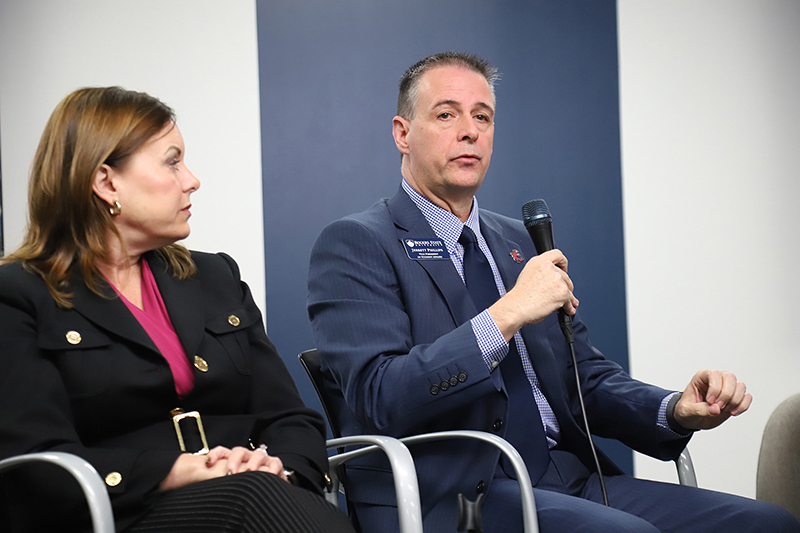 Man panelist speaking into microphone