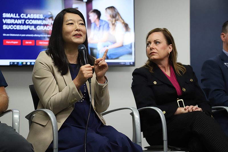 Woman panelist speaking into microphone