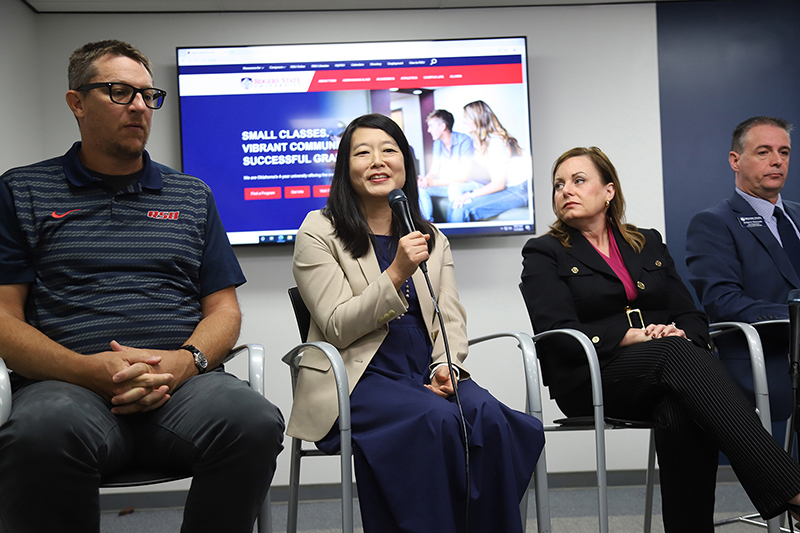 Woman panelist speaking into microphone