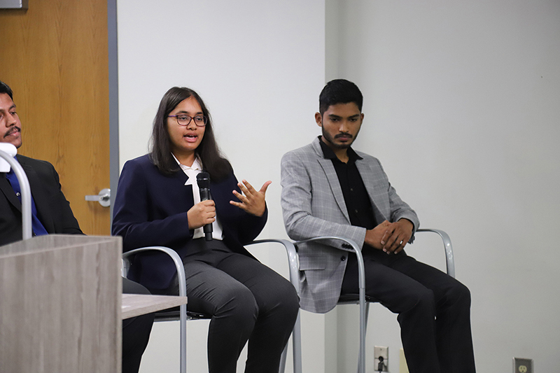 Woman panelist speaking into microphone