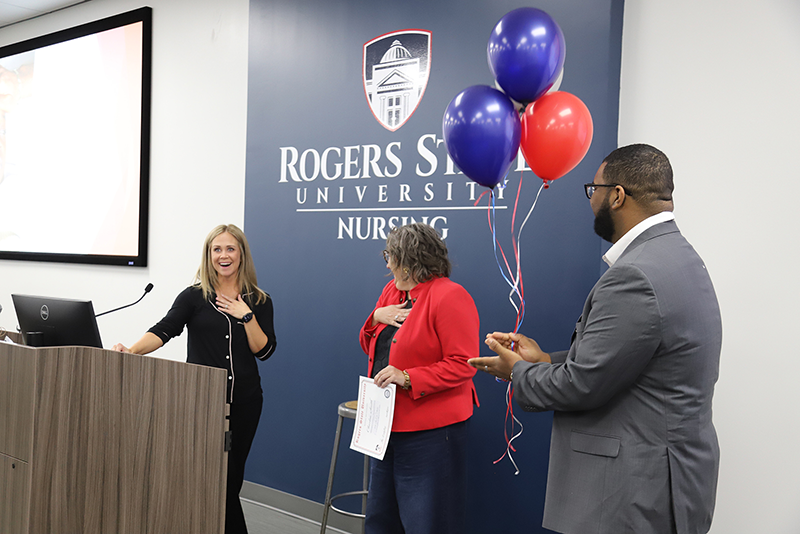 Man handing balloons to woman.