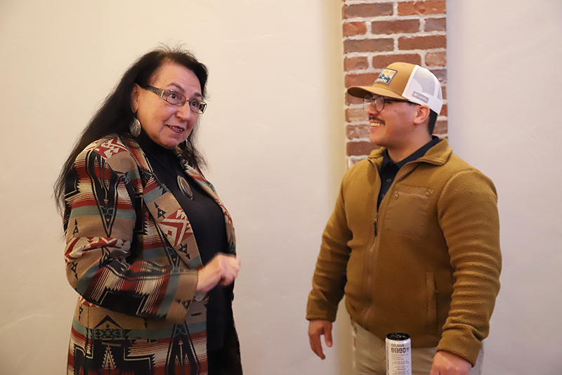 Debra West, Pocahontas Club member (left), visits with RSU Police Officer Ray Torrez at the recent Claremore Chamber of Commerce Biz & Brew event.