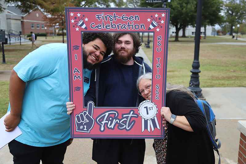 People holding a large frame with First Generation Day written on it