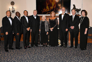 The class of nine members inducted into the Oklahoma Higher Education Hall of Fame stand in a row, left to right