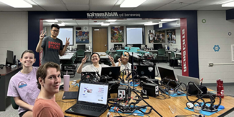 Students in classroom working on robots.