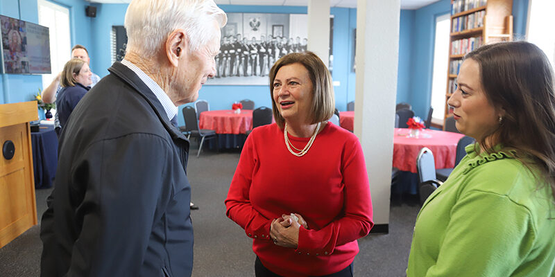 Tonni Harrald (center) visits with former university president Dr. Richard Mosier, along with Harrald's daughter Preslee (right)