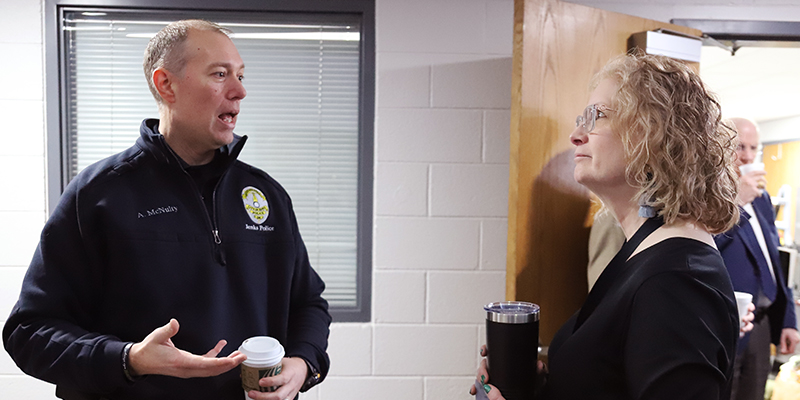 A male law enforcement officer visits with a female RSU employee