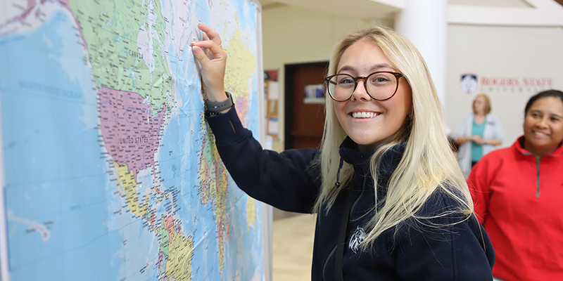 RSU international student Kristin Gudmundsdottir of Iceland places a pin on the map for her home nation.