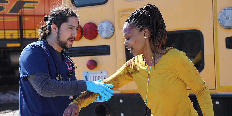 A male RSU nursing student (left) assists another student during a mock disaster drill March 7.