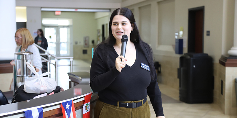 Student Activities Coordinator Meg Thompson speaks during the International Flag Ceremony.