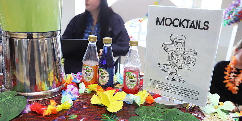 A table with mocktail sign and ingredients