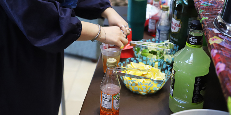 A female RSU employee make a mocktail during Spring Safety Week